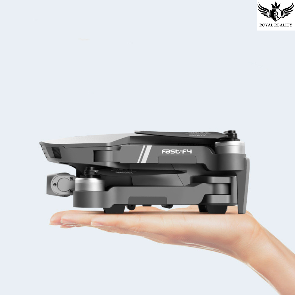 Portable drone held in a hand with a white background