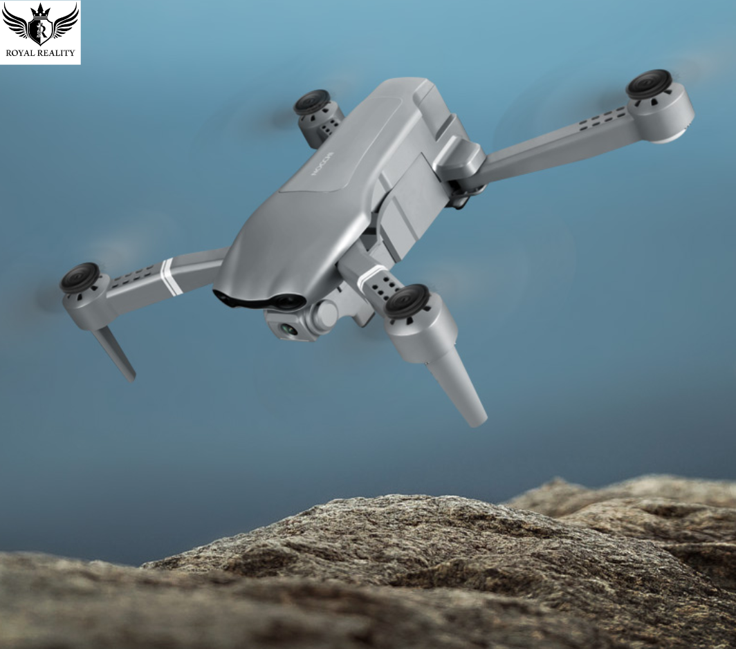 Foldable GPS drone flying above rocky coastline during sunset