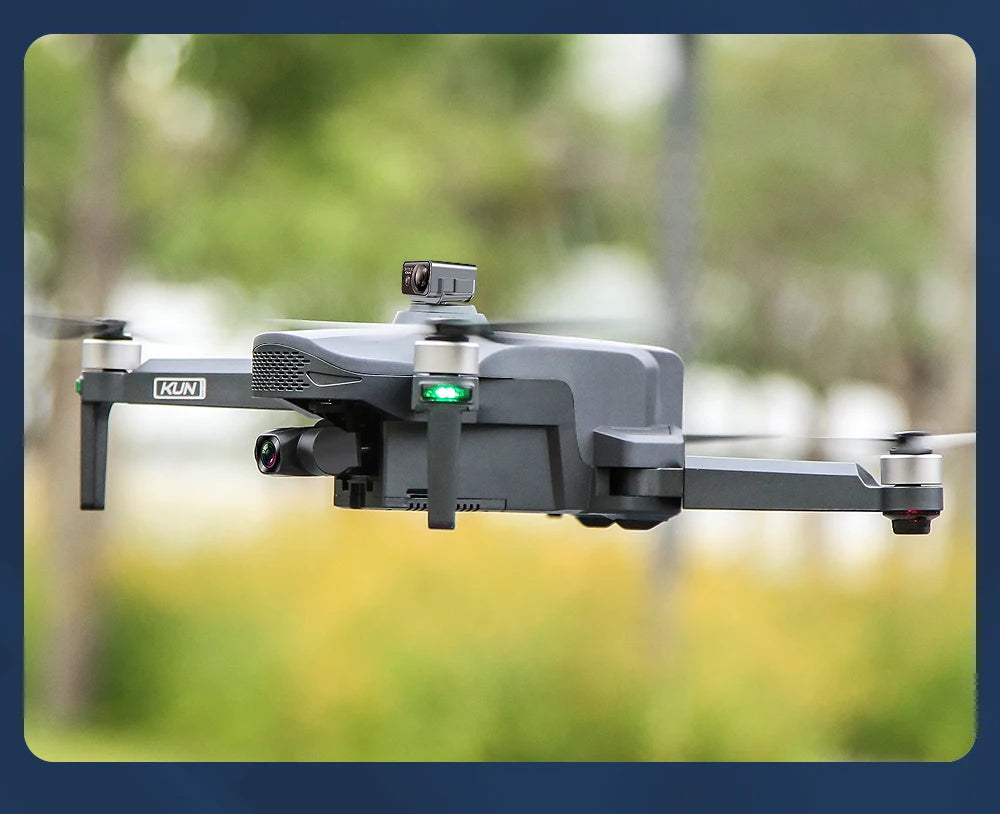 Gray drone with camera flying against a blurred natural background