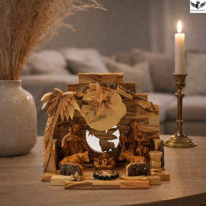 Wooden nativity scene with figures and a candle in a decorative setting.