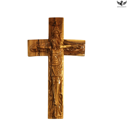 Wooden cross with a carved figure on a white background
