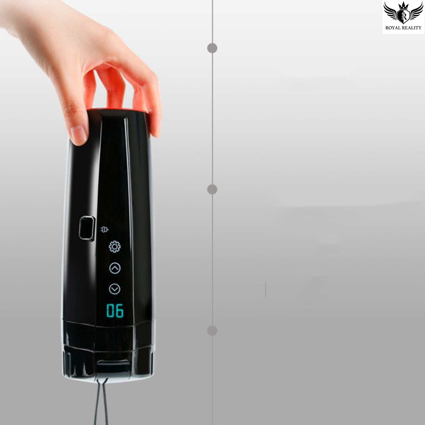 Hand holding a black electronic device with a digital display on a gray background