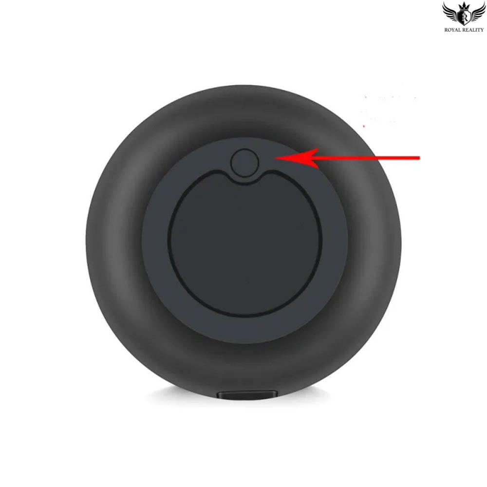 Black circular object with a red arrow pointing to a specific feature on a white background