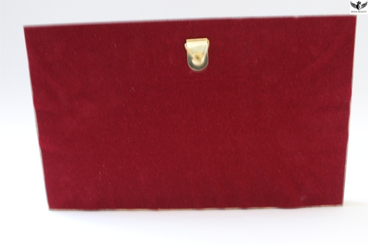 Red clutch bag with a gold clasp on a white background