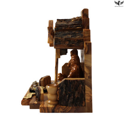 Wooden nativity scene with a manger and figures on a white background